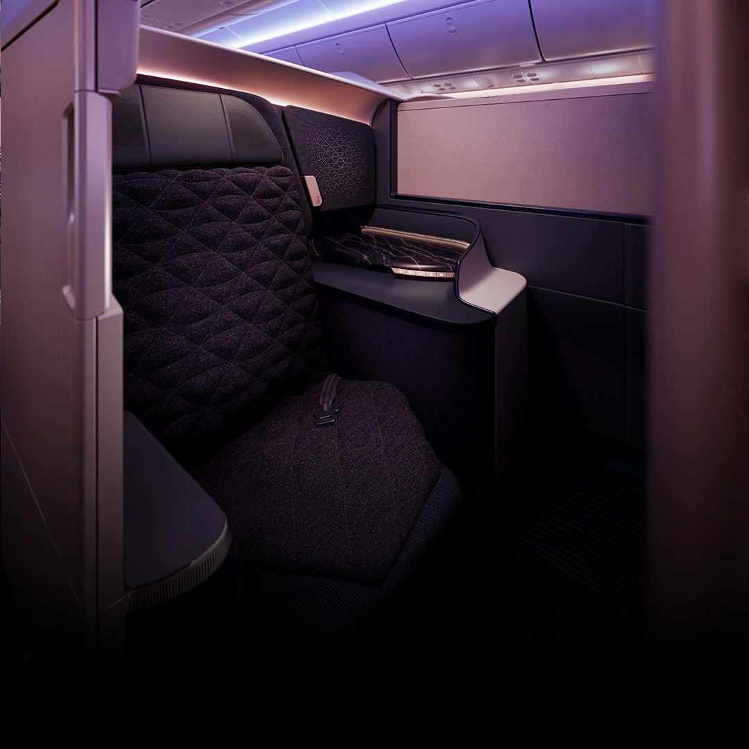 A Riyadh Air Business-class suite on the Boeing 787-9, built on the Safran Unity seat, with privacy walls and ambient lighting.