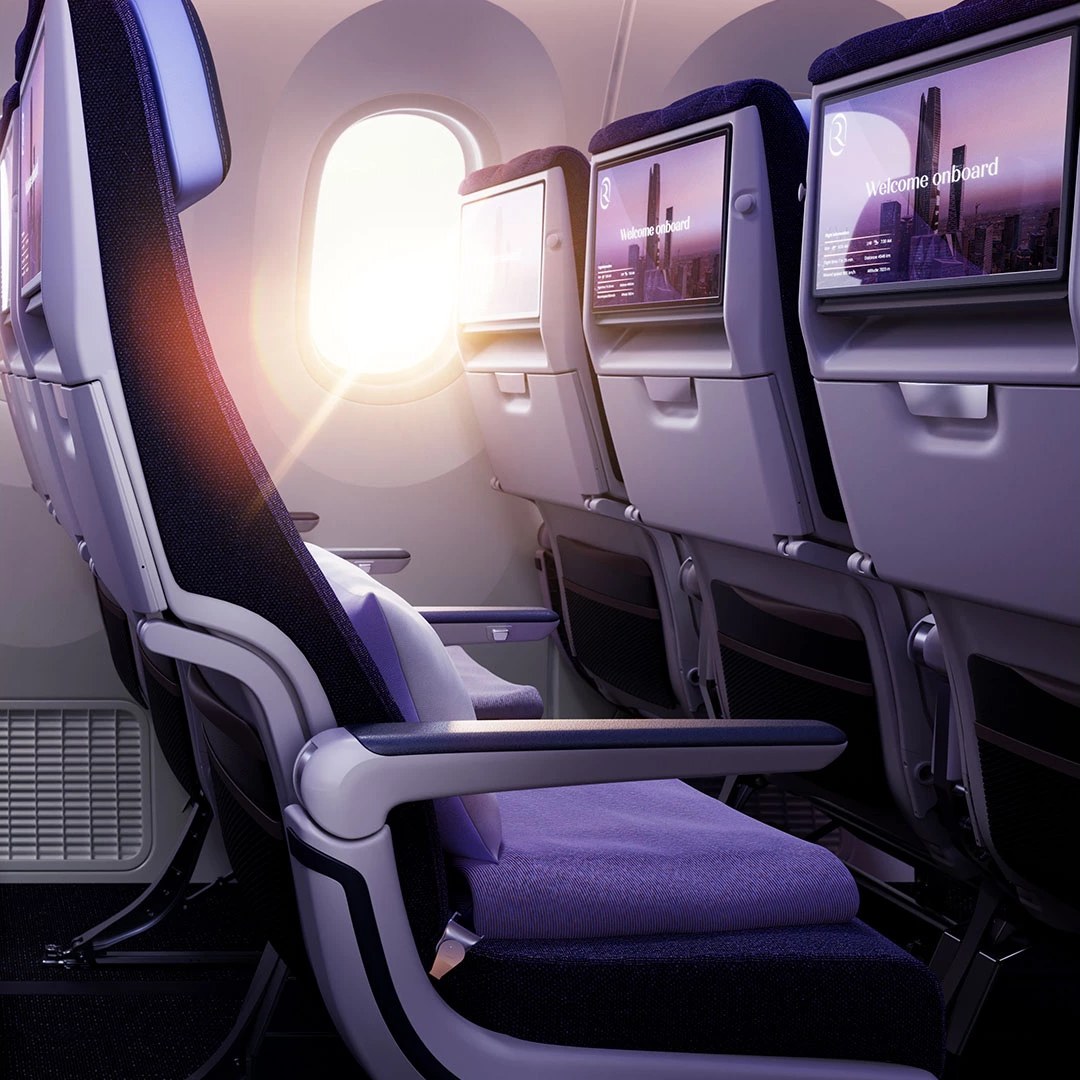 A Riyadh Air Boeing 787-9 Economy cabin, with seatback screens and the airline's violet cabin design.